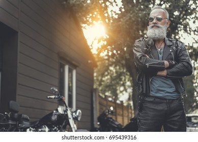 Crackerjack old male person having rest near bike - Shutterstock ID 695439316