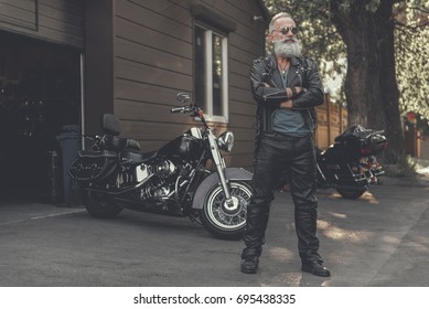 Crackerjack old man locating near motorbike - Shutterstock ID 695438335