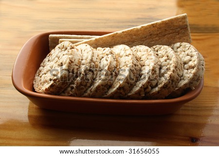 Crackers in brown bowl on wooden table