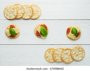 Crackers With Cheese And  Salami  On Vintage Wooden Background.Snacks - Top View