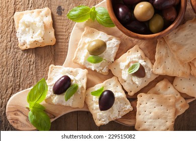 crackers with soft cheese and olives. healthy appetizer  - Powered by Shutterstock