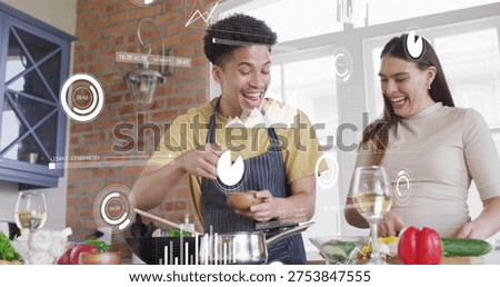 Cracking egg and chopping pepper couple in striped-apron beige-top at kitchen counter, pan, AR HUD. Cooking, duo, home, prep, ingredients, produce, herbs
