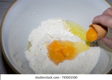 Cracking at egg into flour 
