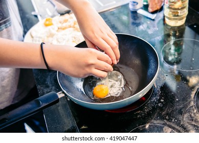 Cracking an egg into a frying pan - Powered by Shutterstock