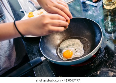 Cracking An Egg Into A Frying Pan