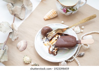 Cracking Ice cream with a fork. Chocolate ice cream with caramel is cracking.