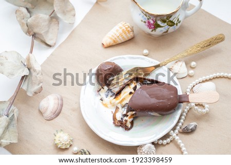 Cracking Ice cream with a fork. Chocolate ice cream with caramel is cracking.