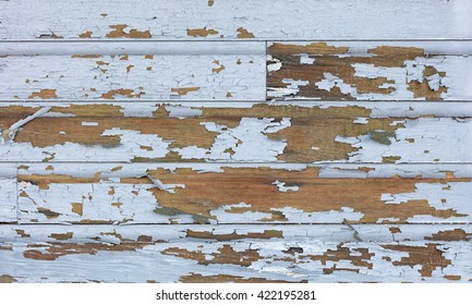 Cracking and peeling lead paint off of wood sliding. 
