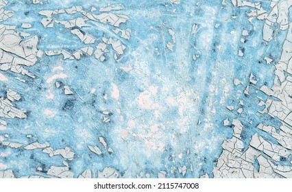 Crackle paint texture. Blue  grunge pattern of natural enamel paint crackle. Cool texture of cracks, stains, scratches, splashes for print and design. Old painted concrete wall.
