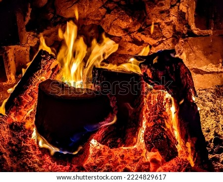 A crackling wood fire in an oldstyle fireplace