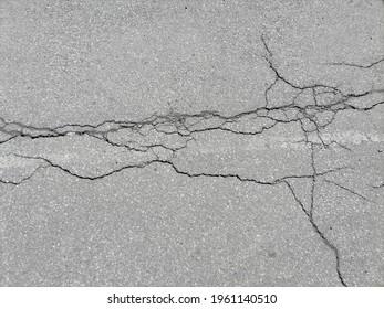 cracks in the asphalt in the city  - Powered by Shutterstock