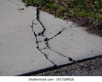 Cracks In Concrete Driveway, Sunken Areas Caused By Heavy Equipment Or Settling