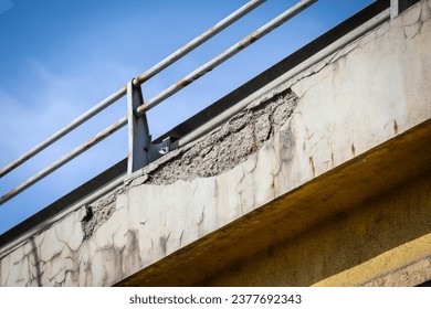 Cracks in the concrete structure of a bridge in a state of decay - Powered by Shutterstock