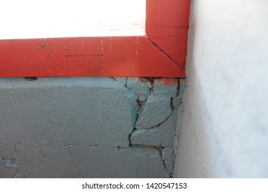 Cracks at the corner of the window in the house, problems with the joints between the wood and cement