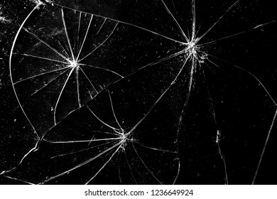 Cracks in the glass on a black background. Abstraction