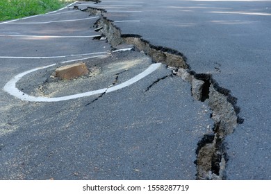 cracks on asphault rural road. damaged collapsed street