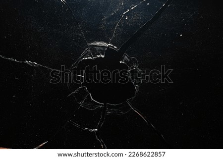 cracks on the glass impact on the glass, abstract background broken window damage