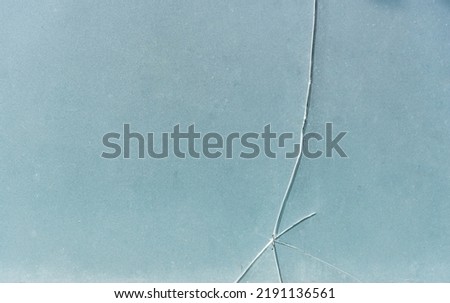 Cracks on glass Thick and opaque glass cracks in vertical, horizontal and oblique lines on the glass surface.