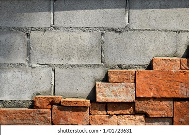 Cracks On The Red Brick Wall Of The Old Building Are Damaged. Wet With Moss And Dog Claw Marks On Shiny Leaf Walls.