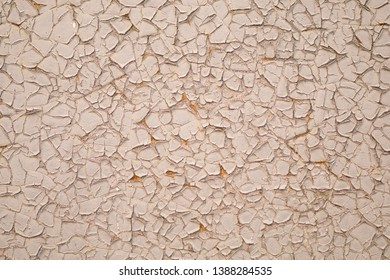 A lot of cracks on the white painted surface of the metallic material. White background texture with several stained background. Multi-layered old painting. Cracked wall.