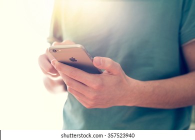 CRACOW - January 02: Man Hand Holding The New IPhone 6s Retina Isolated On Uniform Background, Focus On Apple Logo, Poland On January 02, 2016.