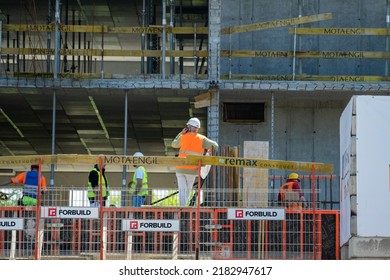 Cracow, Lesser Poland, Poland - 19 May 2022: construction worker talking on the phone