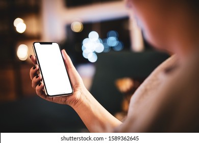 Cracow, Malopolskie / Poland - October 15 2019: Woman Hand Holding IPhone 11 Pro On Bokeh Home Interior Background