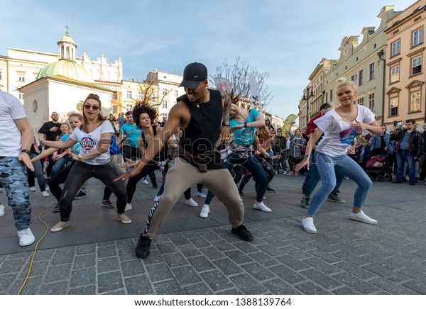 Cracow, Poland - March 30,
2019:  International Flashmob Day of Rueda de Casino. Several
hundred persons dance Hispanic rhythms on the Main Square in
Cracow. Poland 