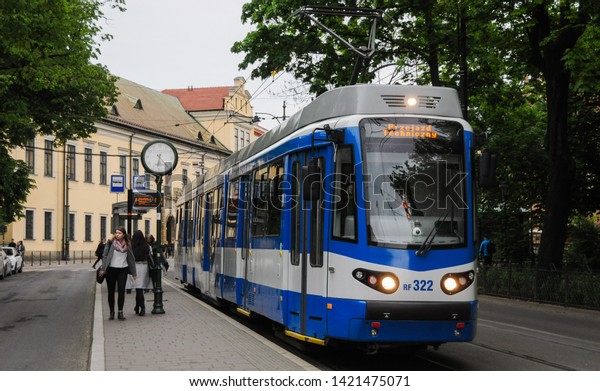 Cracow/Krakow/Poland - MAY 21, 2019: A public\
transport in Krakow, Poland. The  tram on the street of Krakow.\
Cityspace with\
tram.