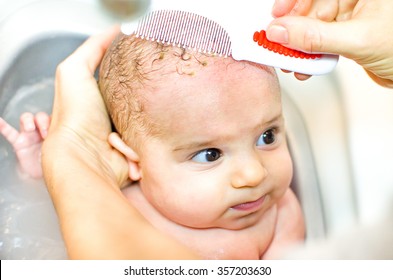 Cradle cap comb removing bathe newborn - Shutterstock ID 357203630
