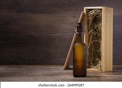 Craft Beer Bottle Mock-up, Beer Bottle Without Label With A Wooden Gift Box Standing On A Rustic Table