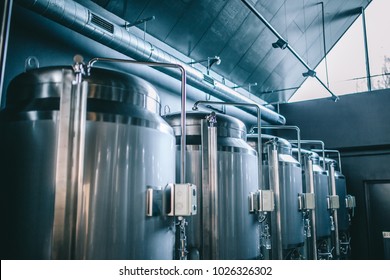 Craft beer brewing equipment in brewery! Metal tanks, alcoholic drink production - Powered by Shutterstock