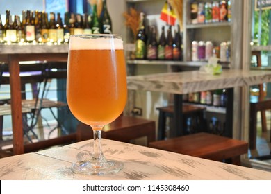 Craft Beer Ipa Glass With Blurred Bar Background