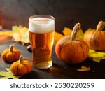 Craft beer on the table with pumpkins and autumn yellow leaves . Celebrate Halloween