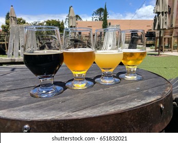 Craft Beer Tasting Flight, Four Beer Glasses On A Table