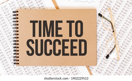 Craft colour notepad with text Time to succeed. Notepad with eyeglasses and text documents. Business concept