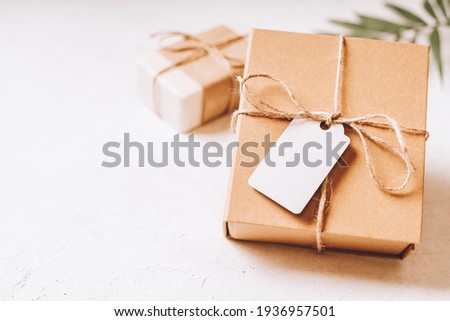 Craft eco Gift or present box with blank mockup tag, bow and on white background. Copy space for text and design. Soap, zero waste, plastic free, eco friendly concept.