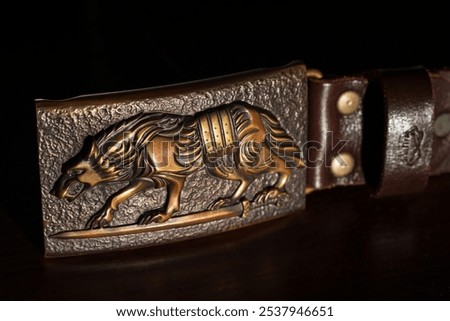 craft hand made forged pattern wild wolf shape pattern on badge for belt close up object view