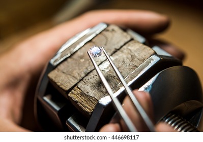 Craft jewelery making with professional tools. Ring repairing. Putting the diamond on the ring. Macro shot.  A handmade jeweler process, manufacture of jewelery. - Shutterstock ID 446698117