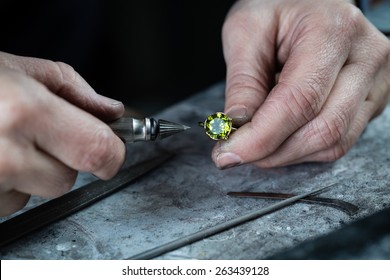 Craft jewelery making. Repairing ring by inlaid tight gem.