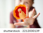 craft for kids. DIY felt Turkey for thanksgiving day. create art for children. girl playing with finger toy.