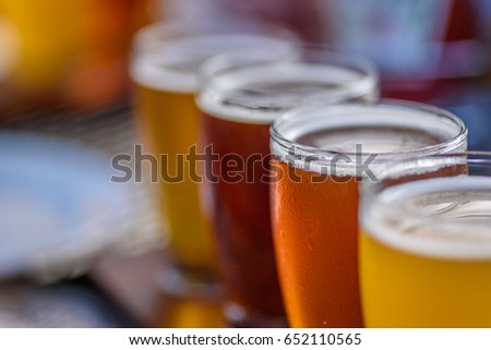 Craft micro brewery beer flight on paddle in sunlight - macro with selective focus