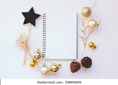 Craft and notebook mock up with christmas ornaments on white wood background  - Powered by Shutterstock