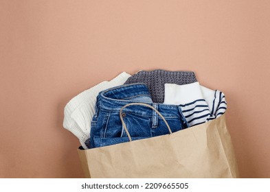 Craft Paper Bag With Full Of Used Clothing  For Recycling Or Donation. Second Hand Wardrobe Idea. Recycle Clothes, Eco Cotton. Donation To The Needy