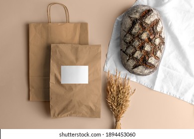 Craft paper blank shopping bags with bread, bakery branding mockup, empty space to display your logo or design.