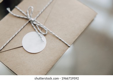 Craft paper envelope tied with a rope. Blank paper sticker to copy space your personal logo. Wedding invitations on the table. - Powered by Shutterstock