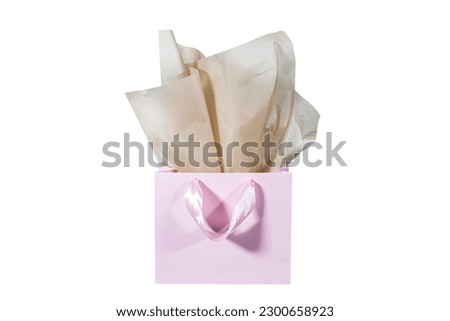 Craft paper gift bag with tissue paper isolated on a white background