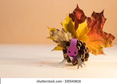 Craft turkey toy, handmade article made of pine cone and autumn leaves. Thanksgiving Day decoration.  