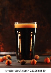 Craft walnut stout with hazelnuts. A glass of dark draft beer