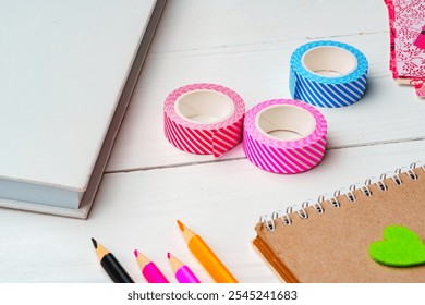 Crafting inspiration with colored pencils, decorative tape, and playful shapes on a rustic wooden surface - Powered by Shutterstock